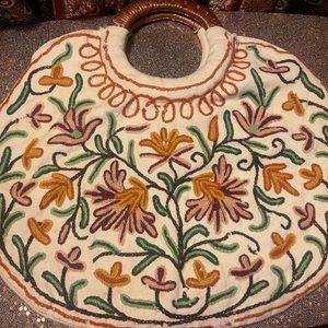 Vintage round embroidered cloth bag w/ wicker handle.